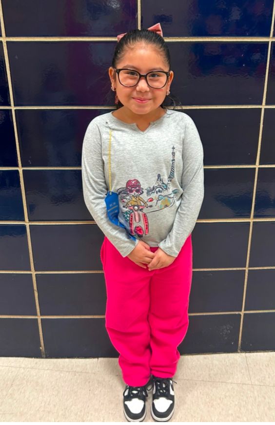 Student ambassador in glasses, a gray top and pink pants
