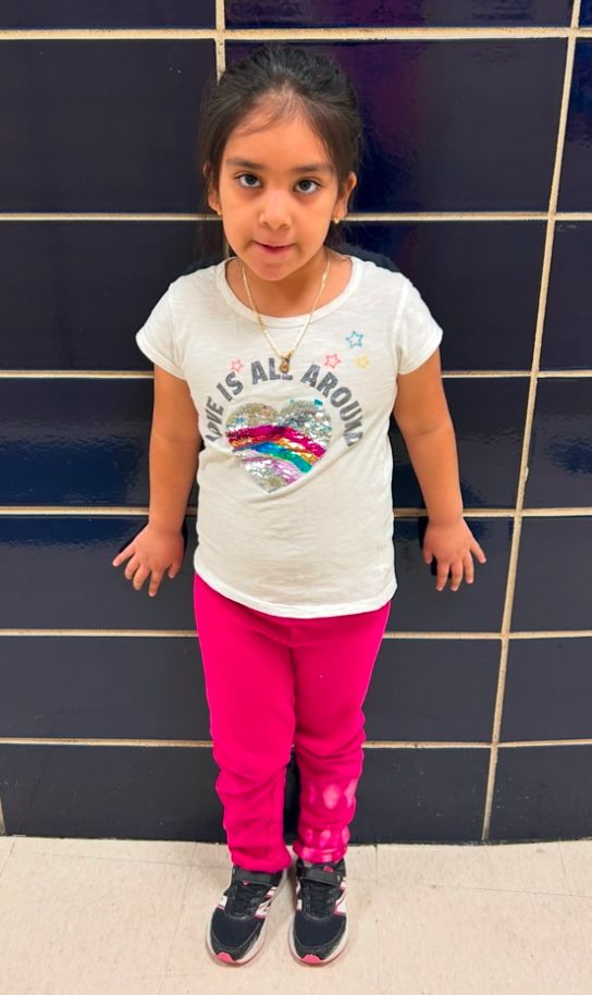Student ambassador in a white shirt and pink pants