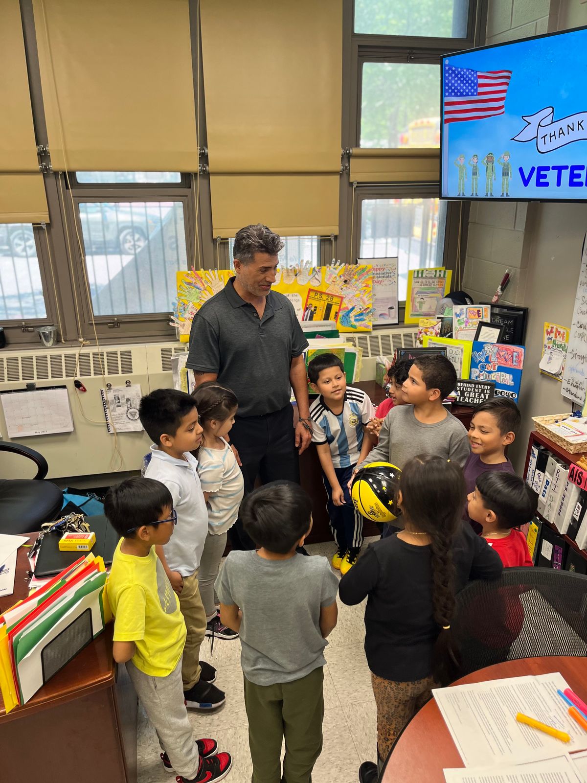 The team gathered around their coach in a classroom
